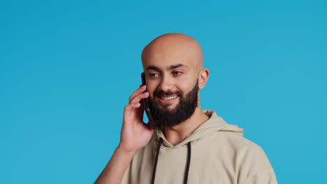Middle-eastern-guy-chatting-with-friends-on-phone-call