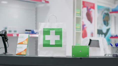 Paper-bag-with-medicine-and-greenscreen-surface-shown-on-pills-box