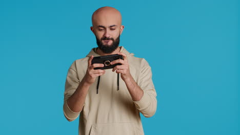 Middle-eastern-guy-enjoying-video-games-contest-on-camera