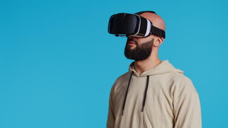 Middle-eastern-adult-using-virtual-reality-glasses-in-studio