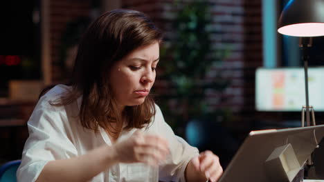 Worker-frustrated-by-mistake-she-made-while-inputting-data-on-laptop