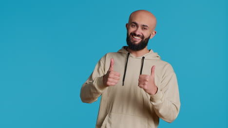 Middle-eastern-person-giving-thumbs-up-on-camera