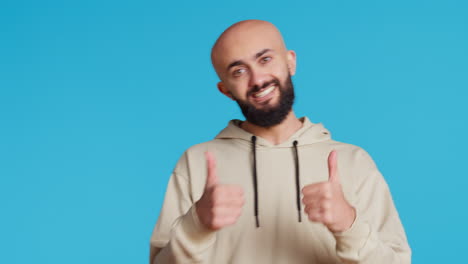 Middle-eastern-person-giving-thumbs-up-on-camera