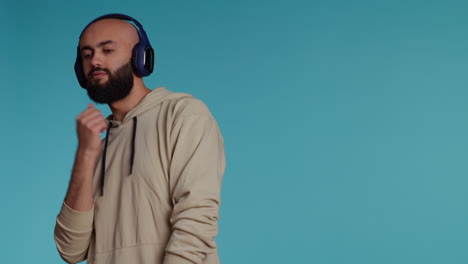 Muslim-person-listening-to-happy-tunes-on-headphones