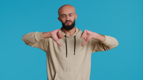 Middle-eastern-guy-showing-thumbs-down-sign-on-camera