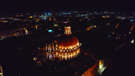 Close-Drone-of-Dome-Cathedral-Lit-Up-at-Night,-Basilica-of-Our-Lady-in-Valletta,-Malta