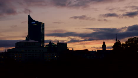 Silhouette-of-Leipzig-Skyline-under-Dramatic-Sky-and-Colorful-Sunset