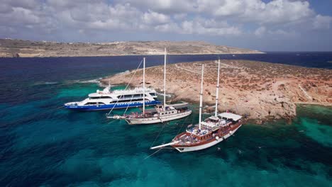 Low-Aerial-Orbit-Around-Traditional-Pirate-Ship-for-Day-Trip-to-Blue-Lagoon,-Malta
