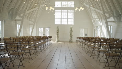 Rustic-Bright-White-Barn-Wedding-Venue-Interior-with-Aisle-and-Chairs