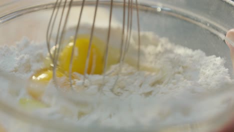 Whisking-Together-Flour-and-Eggs-in-Glass-Bowl
