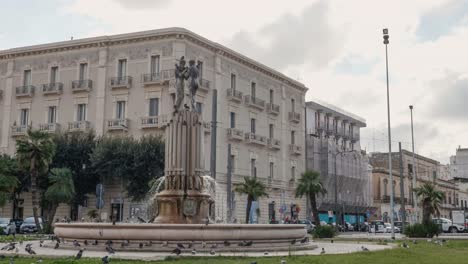 Fontana-dell-Armonia-in-front-of-Charles-V-Castle-in-Lecce,-Italy-in-cloudy-day