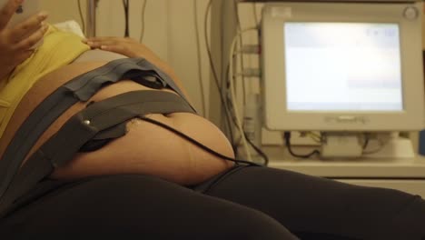 Pregnant-woman-strapped-up-the-hospital-monitor