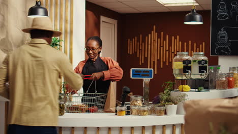 African-american-woman-greeting-client-at-checkout-counter
