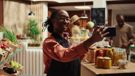 Zero-waste-store-employee-filming-their-natural-products-in-recyclable-jars