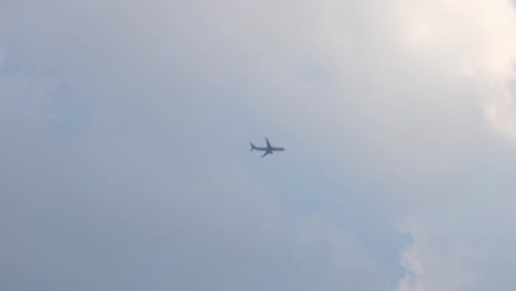 Seen-flying-towards-the-right-from-dark-clouds-to-bright-sky-after-take-off,-Nok-Air,-Don-Mueang-International-Airport,-Bangkok,-Thailand