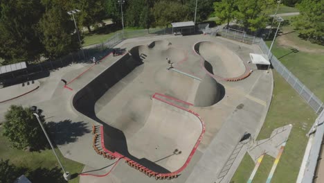 An-ascending-drone-aerial-view-of-skateboarders-at-Lee-and-Joe-Jamail-Skatepark-in-Buffalo-Bayou-Park-in-Houston-Texas