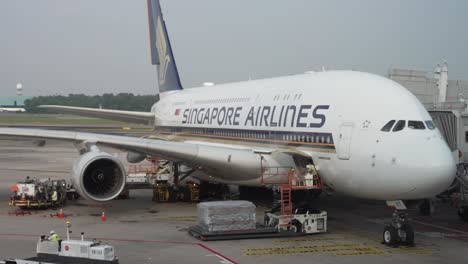 Cargo-Being-Loaded-by-Lifter-Beside-Singapore-Airlines-A380-With-Cargo-Bay-Door-Open-At-Changi-Airport