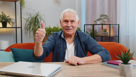 Happy-senior-old-man-looking-approvingly-at-camera-showing-thumbs-up-like-positive-sign-good-news