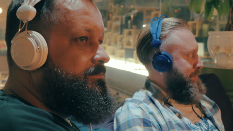 Bearded-men-in-headphones-enjoying-music