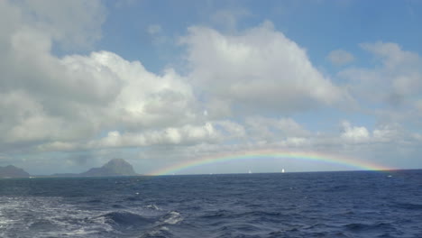 View-of-rainbow-against-blue-sky-with-clouds-in-Indian-Ocean-Mauritius-Island