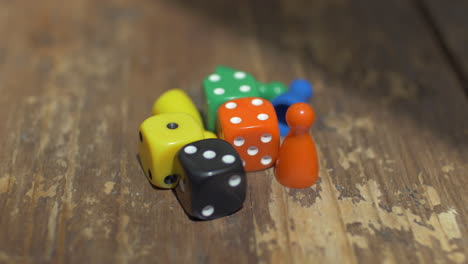 Game-dice-and-counters-on-wooden-table