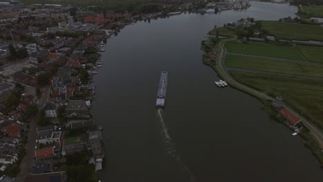 Aerial-view-of-town-and-river-with-sailing-ship-Netherlands