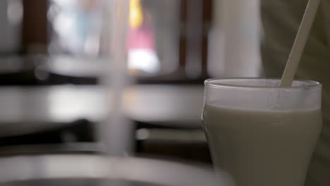 Person-drinking-horchata-in-cafe