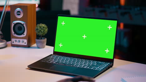 University-student-checks-greenscreen-display-on-laptop-at-home