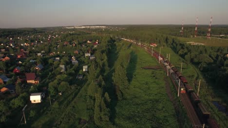 Cargo-trains-moving-through-the-village-aerial-view