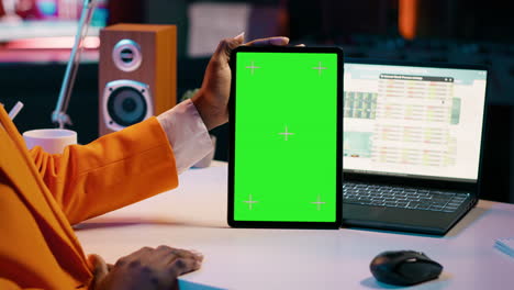 African-american-girl-holding-tablet-with-greenscreen-layout