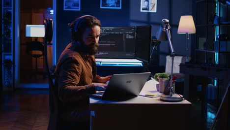 Developer-typing-complex-code-in-neon-lit-home-office,-listening-music