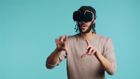 Man-wearing-virtual-reality-headset,-doing-swiping-gestures,-studio-background