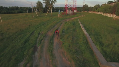 Teenager-riding-bike-in-the-country-aerial-view
