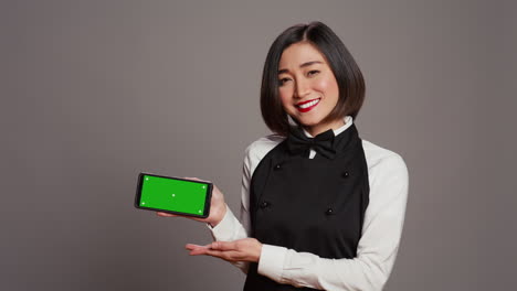 Catering-employee-holding-phone-with-greenscreen-display