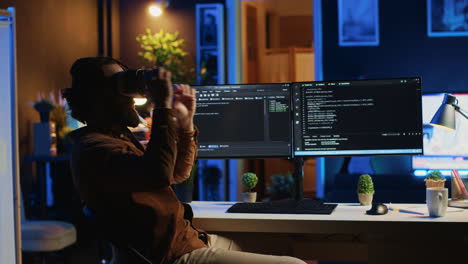 IT-expert-wearing-high-tech-virtual-reality-headset-to-visualize-lines-of-code