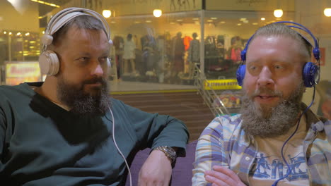 Two-bearded-men-listening-to-music-in-headphones