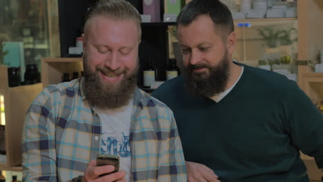 Two-bearded-men-using-smart-phone