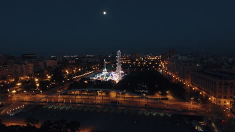 Aerial-shot-of-night-Valencia-with-amusement-park