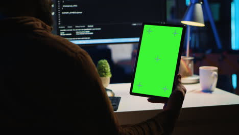 Software-developer-programming-in-home-office-with-green-screen-tablet