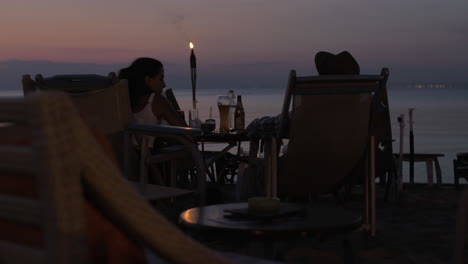 Couple-spending-evening-in-cafe-on-the-beach