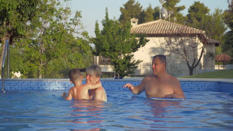 Grandparents-and-grandson-having-fun-in-the-pool