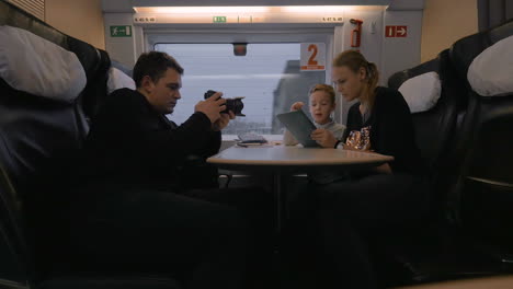 Creating-footage-of-mom-and-child-using-pad-during-train-travel