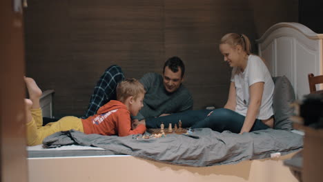 Child-setting-his-own-rules-during-chess-play-with-mom