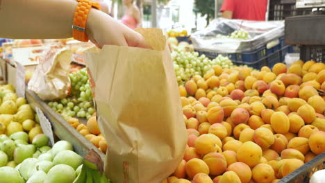 Buyer-Putting-Apricots-into-Paper-Bag