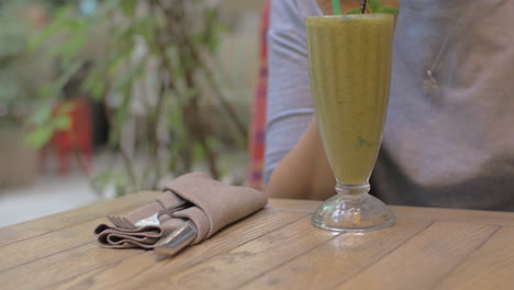 Drinking-mint-smoothie-in-cafe