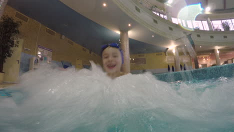 Joyful-kid-enjoying-hydromassage-in-the-pool