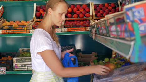 Young-woman-choosing-pears-in-fruit-shop
