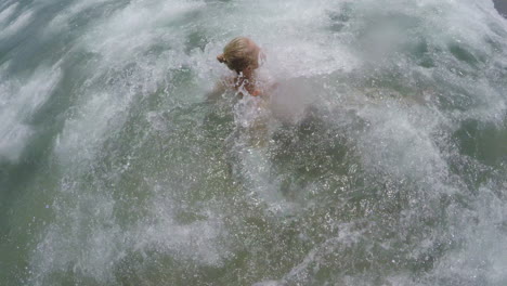 Sea-wave-hitting-swimming-woman