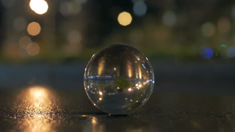 Glass-sphere-on-the-road-in-night-city