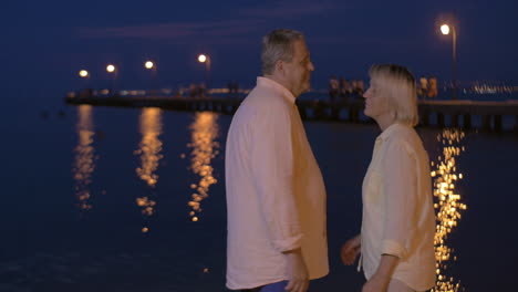Senior-couple-in-love-by-the-sea-at-night